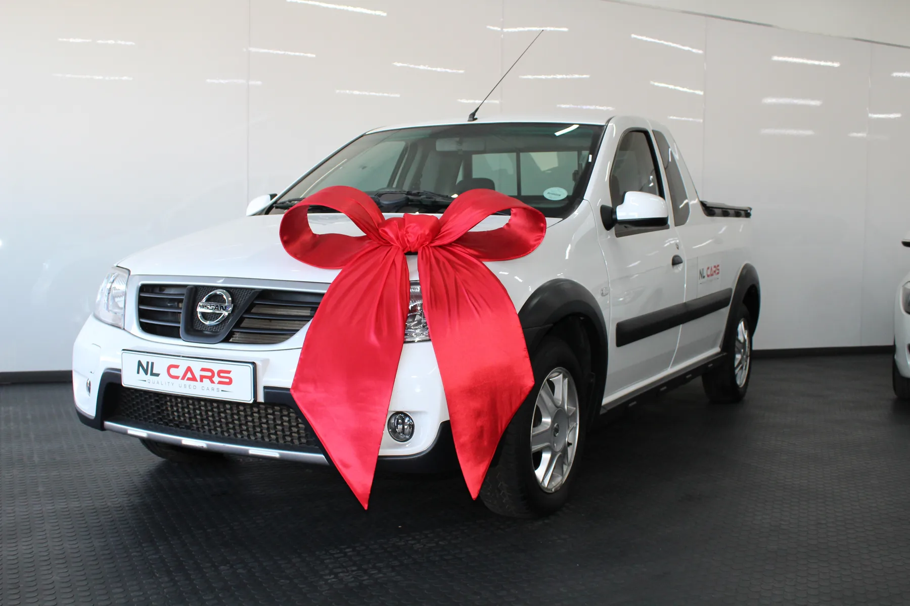 A bakkie with a red bow on the bonnet, ready to be collected